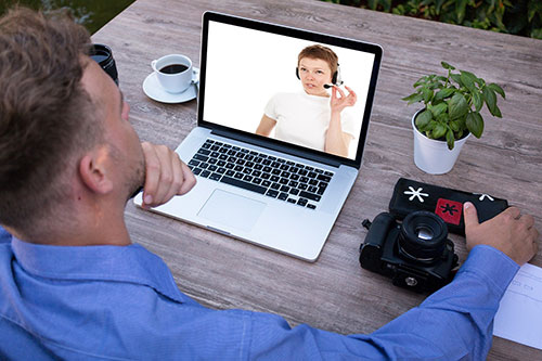 student on laptop doing a video call with instructor