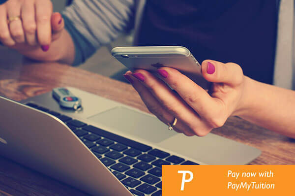 Student paying for courses on laptop and phone