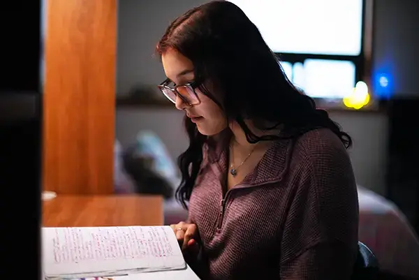 Student studying in a College of the North Atlantic residence room